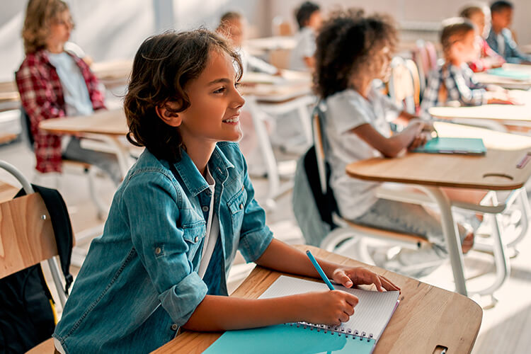 Middle school student participating and smiling in class