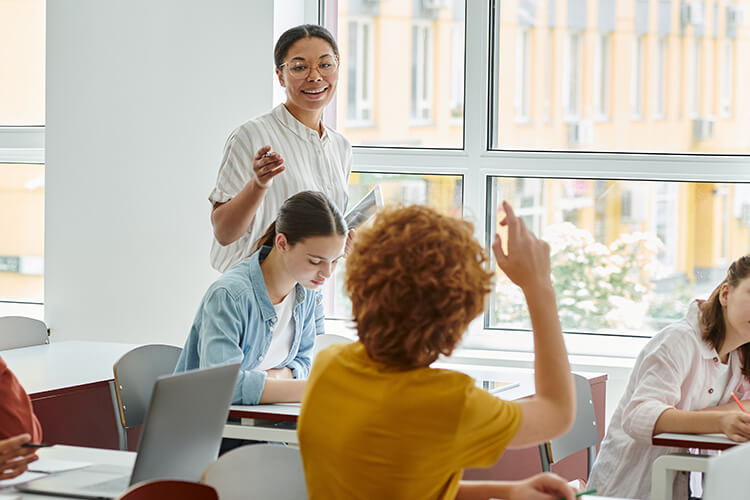 Teacher picking on student who is raising his hand