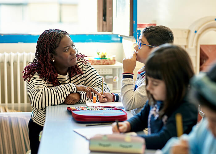 Teacher helps an elementary-aged student